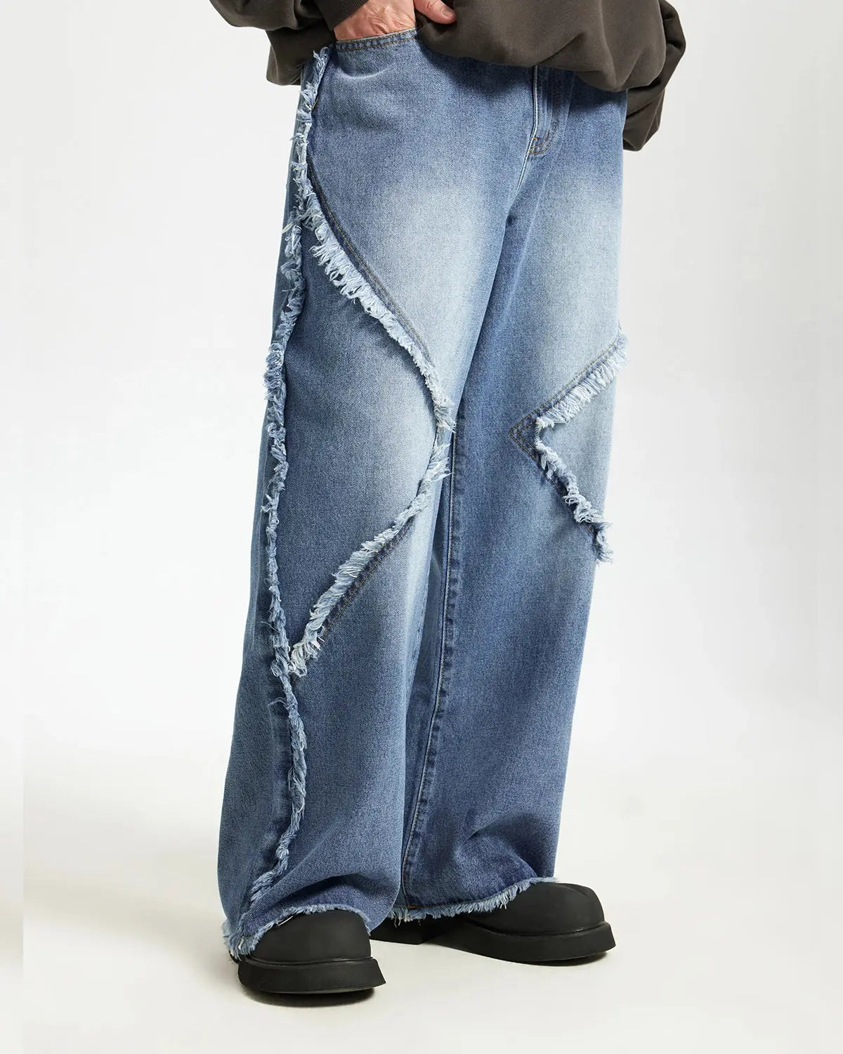 Blue frayed acid wash pants from INFLATION Streetwear, featuring relaxed fit and distressed details.