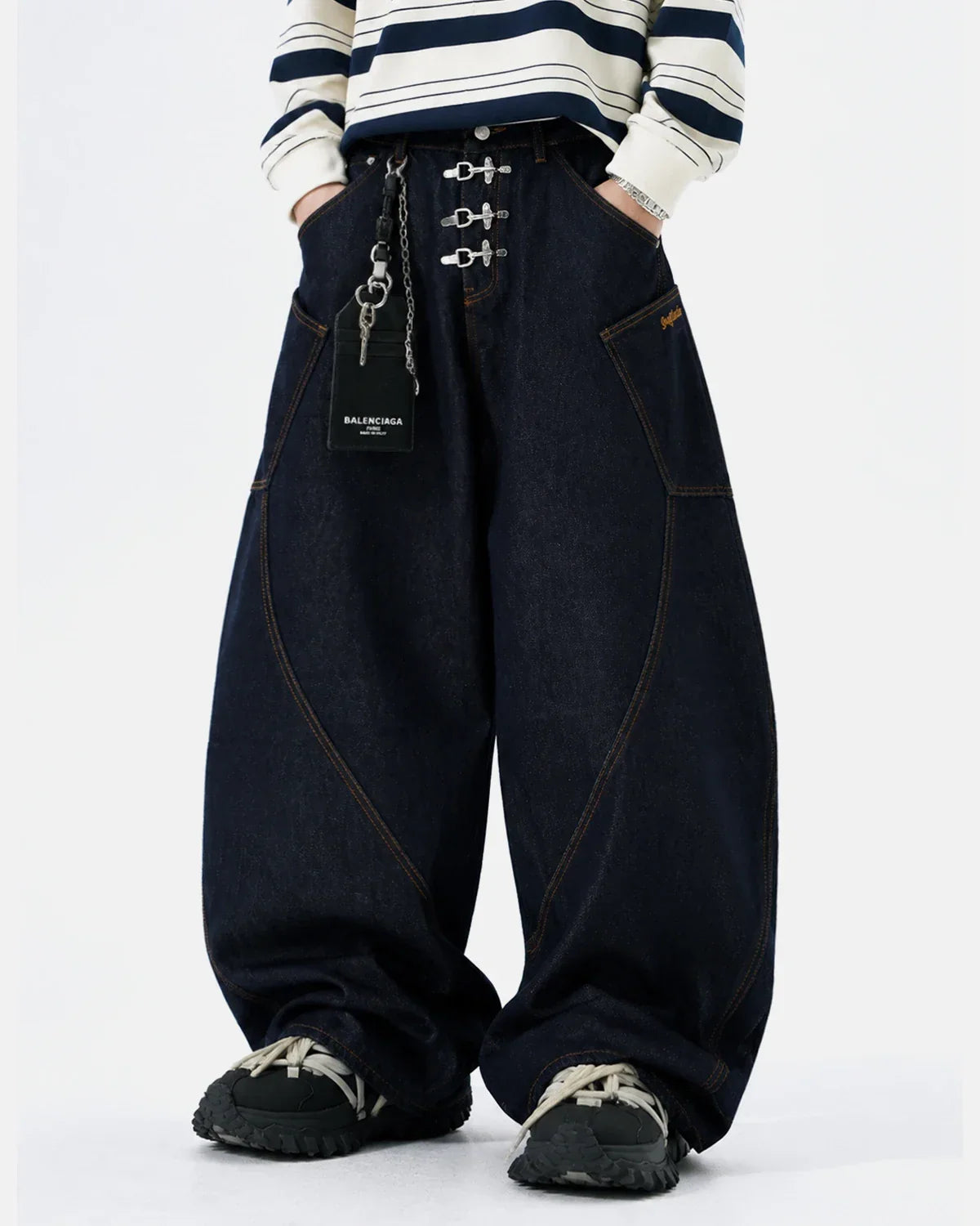 Raw barrel jeans by INFLATION featuring metal clasp hardware and classic denim construction.