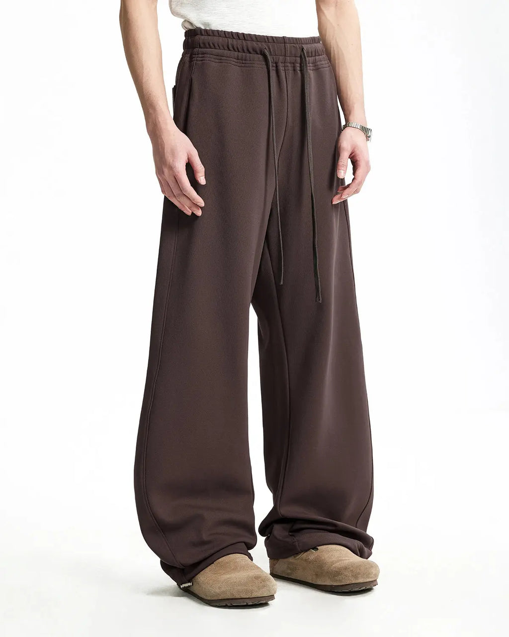 Gray baggy sweatpants by INFLATION with a relaxed fit and drawstring waist, shown on a model against a neutral background.