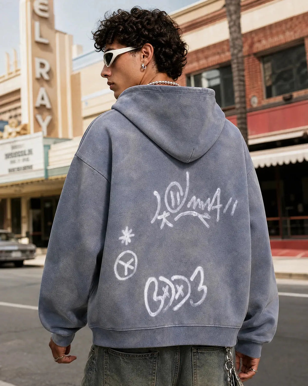 INFLATION graffiti washed zip-up hoodie with colorful graffiti design, casual fit, and front pocket, displayed on a hanger.