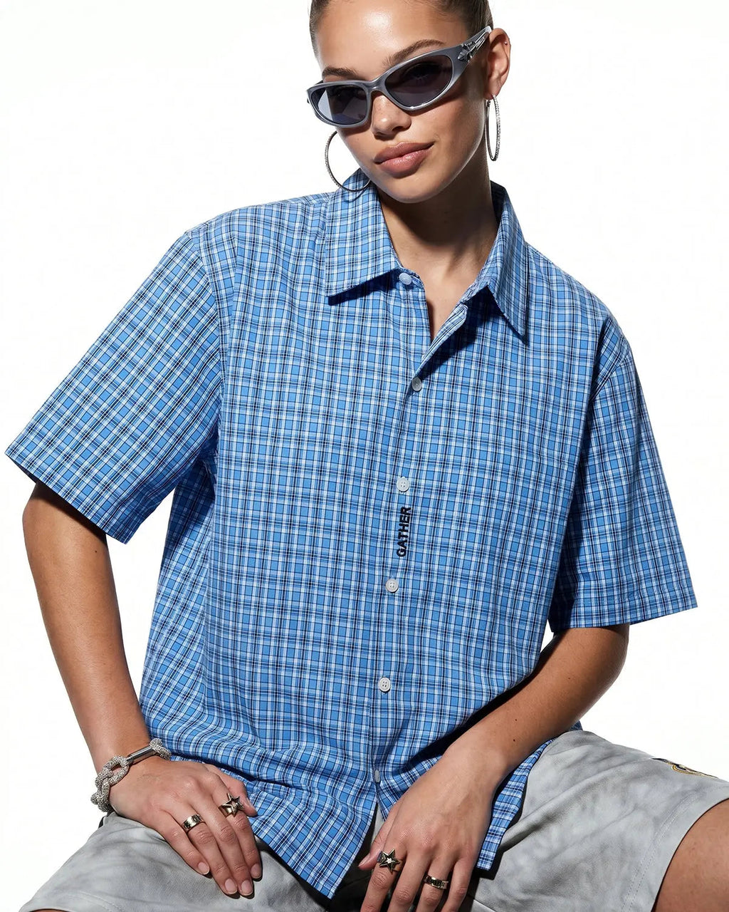 Plaid script embroidered short-sleeve shirt by INFLATION featuring a casual design with embroidered branding on the front.