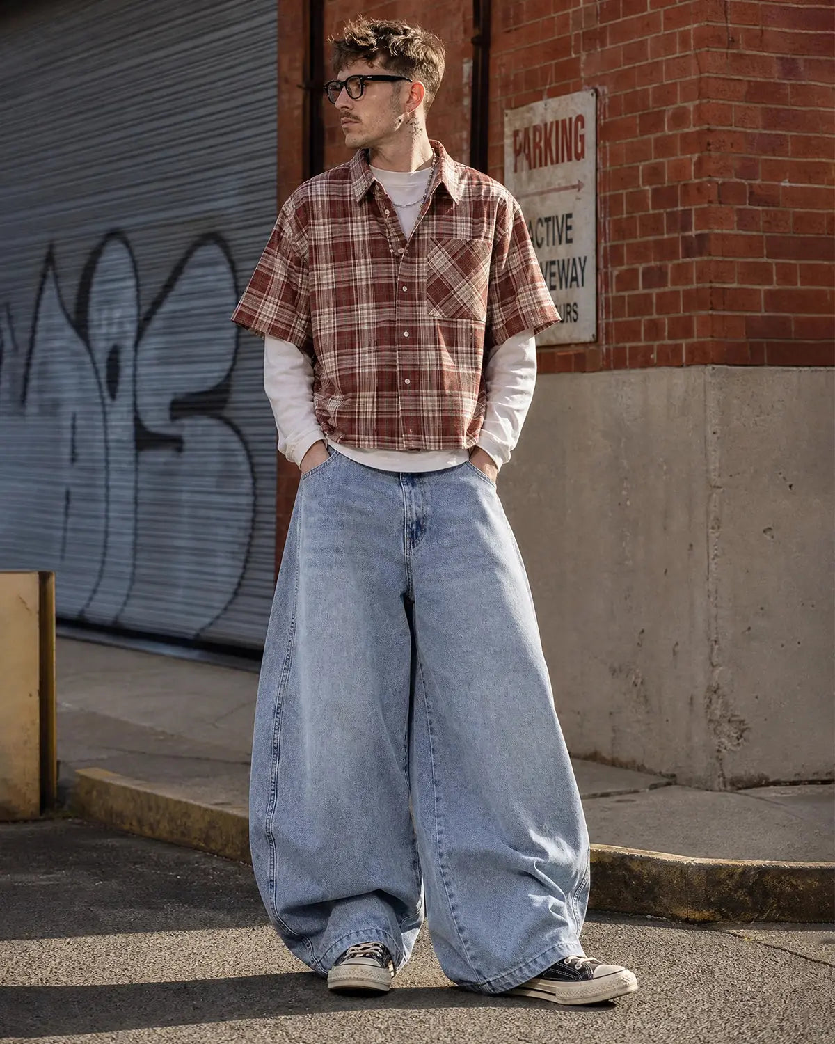 Acid washed distressed barrel jeans by INFLATION, casual streetwear pants with a faded, worn-in look and relaxed fit.