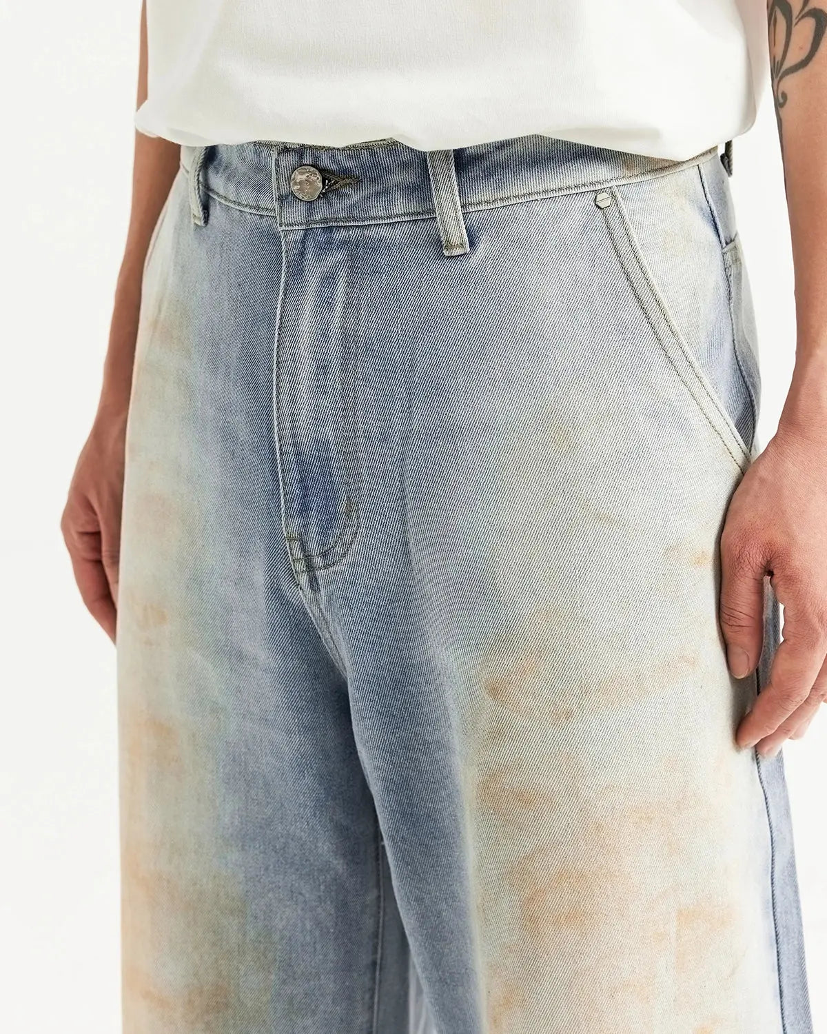 Inflation streetwear Mud Washed Baggy Jeans with distressed denim texture and relaxed fit, shown on a model against a neutral background.