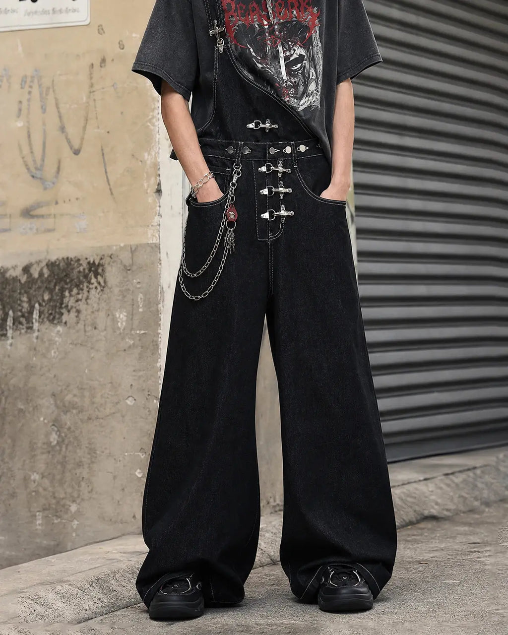 Asymmetric buckle denim overalls jeans by INFLATION, showcasing stylish design and adjustable straps on a pair of casual pants.