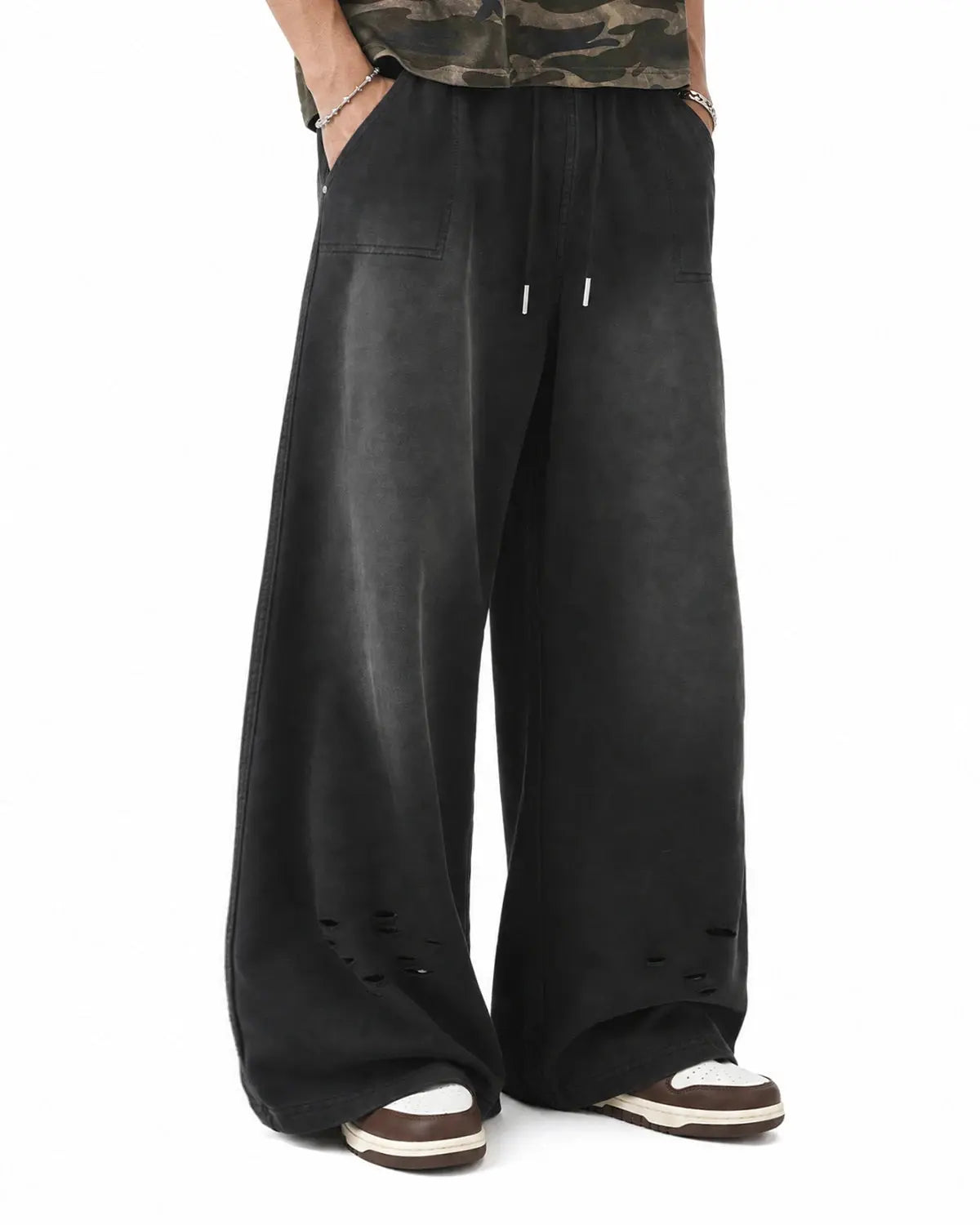Distressed washed baggy sweatpants by INFLATION Streetwear, showing relaxed fit, faded denim look, and frayed details.