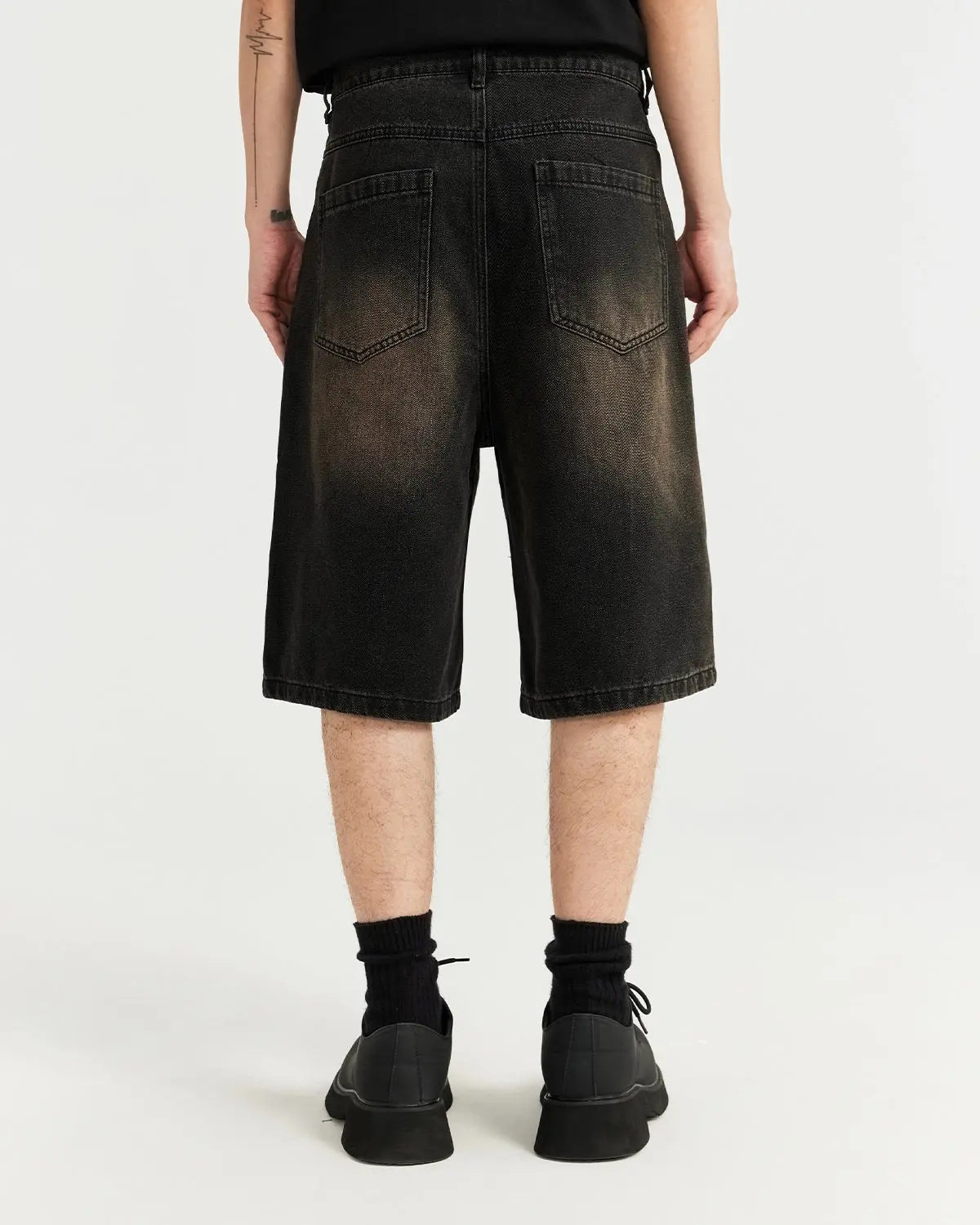 Pair of vintage-style washed denim jorts from INFLATION, featuring distressed details and a relaxed fit for casual streetwear.