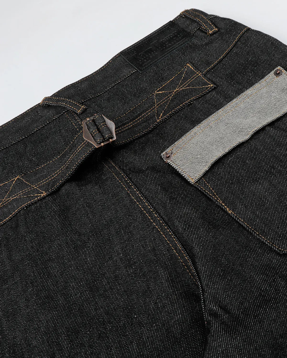 Inflation streetwear raw baggy jeans with button fly, relaxed fit, showcasing denim fabric and casual streetwear style.