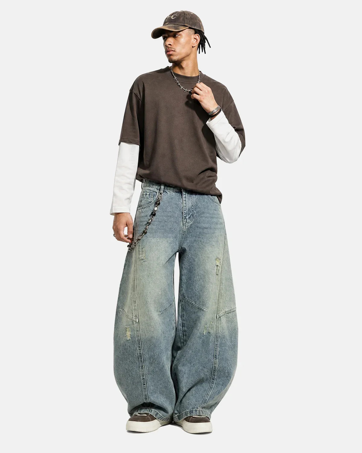 Acid washed distressed barrel jeans by INFLATION featuring a relaxed fit, worn-out details, and faded denim texture.