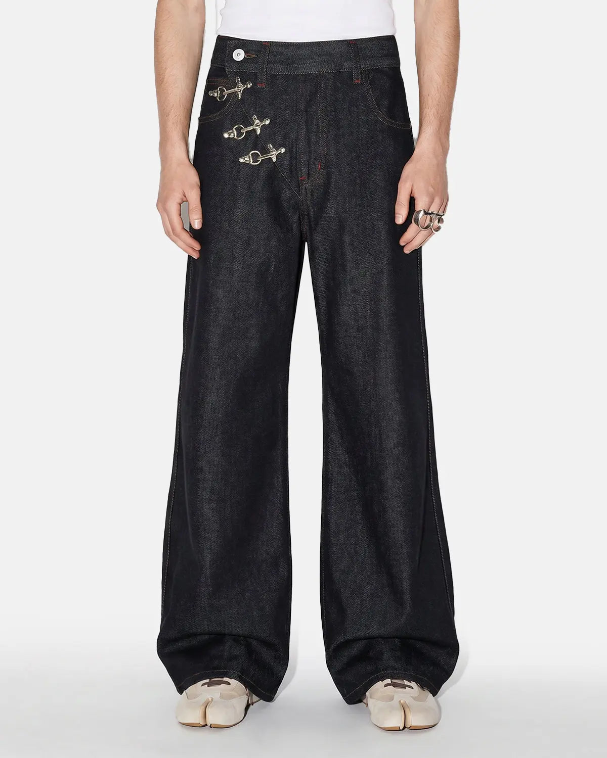 Inflation Streetwear asymmetric buckle raw baggy jeans with distressed details and loose fit, displayed on a model.