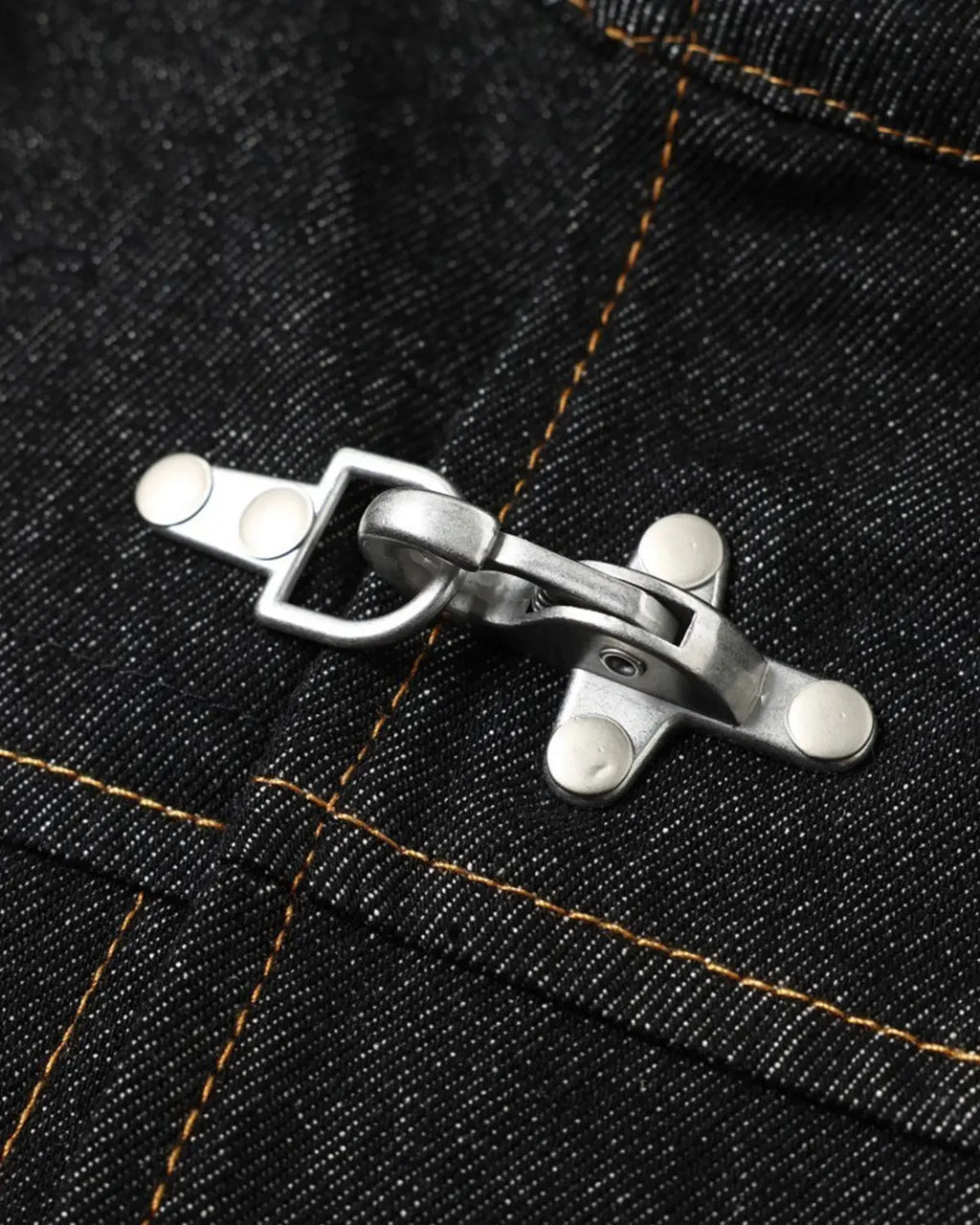 Metal toggle raw denim jacket by INFLATION, stylish streetwear with metal accents and classic raw denim fabric.