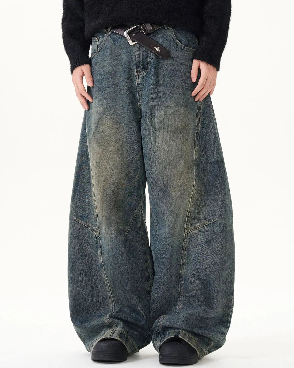 Washed deconstructed barrel jeans by INFLATION, featuring distressed details and a relaxed streetwear fit.