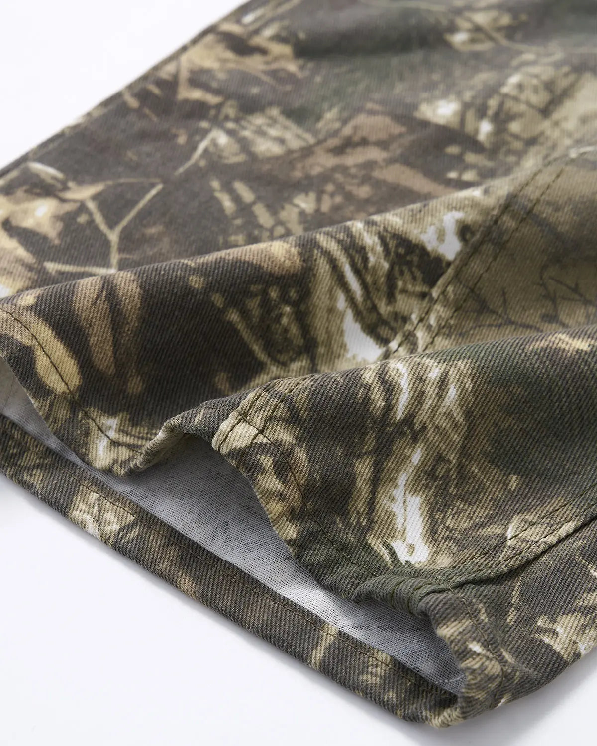 Pink embroidered camo baggy pants by Inflation Streetwear with detailed embroidery and relaxed fit, shown on a model.