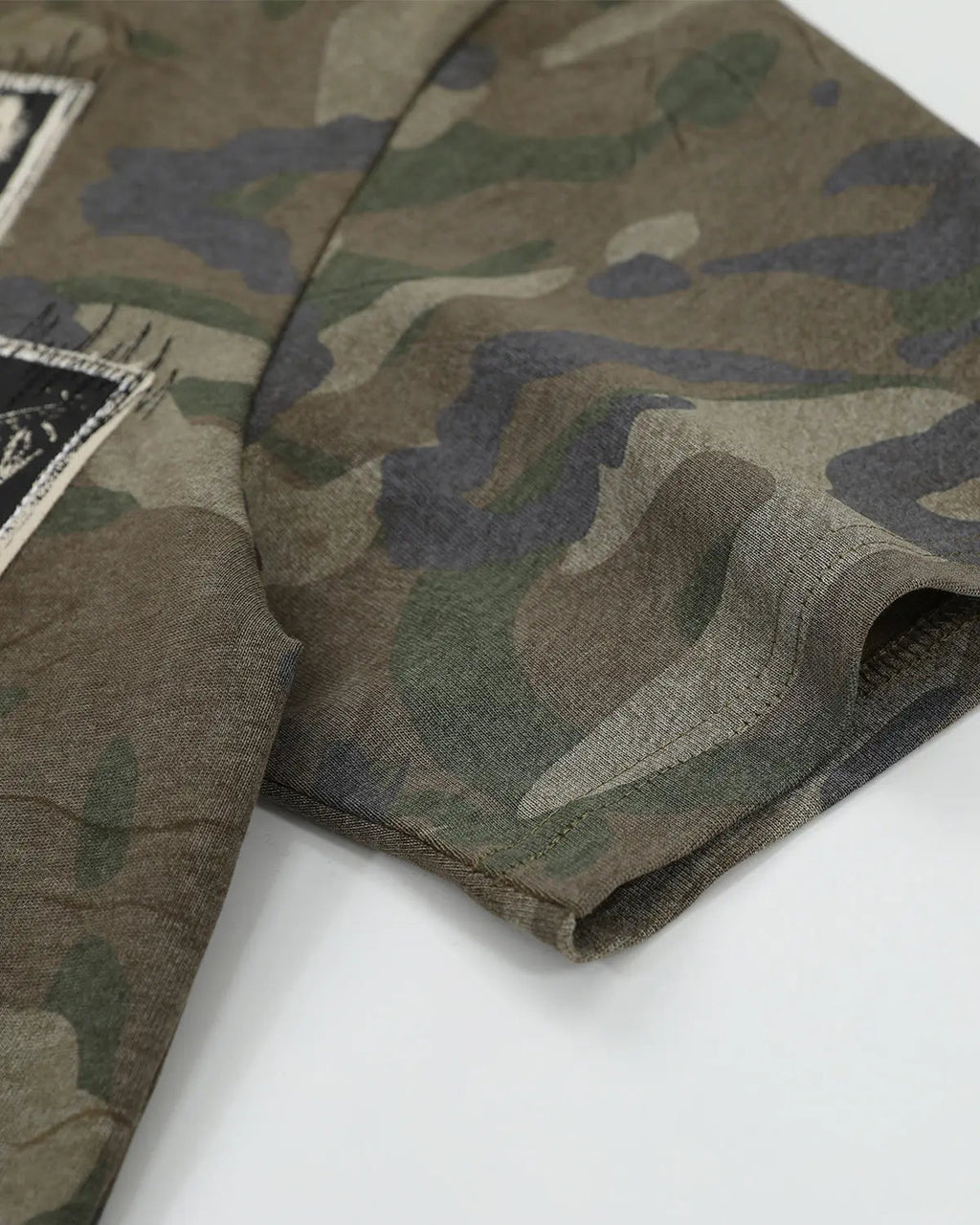 Vintage camo patch graphic T-shirt by INFLATION, featuring a streetwear design with bold camouflage and patch details.