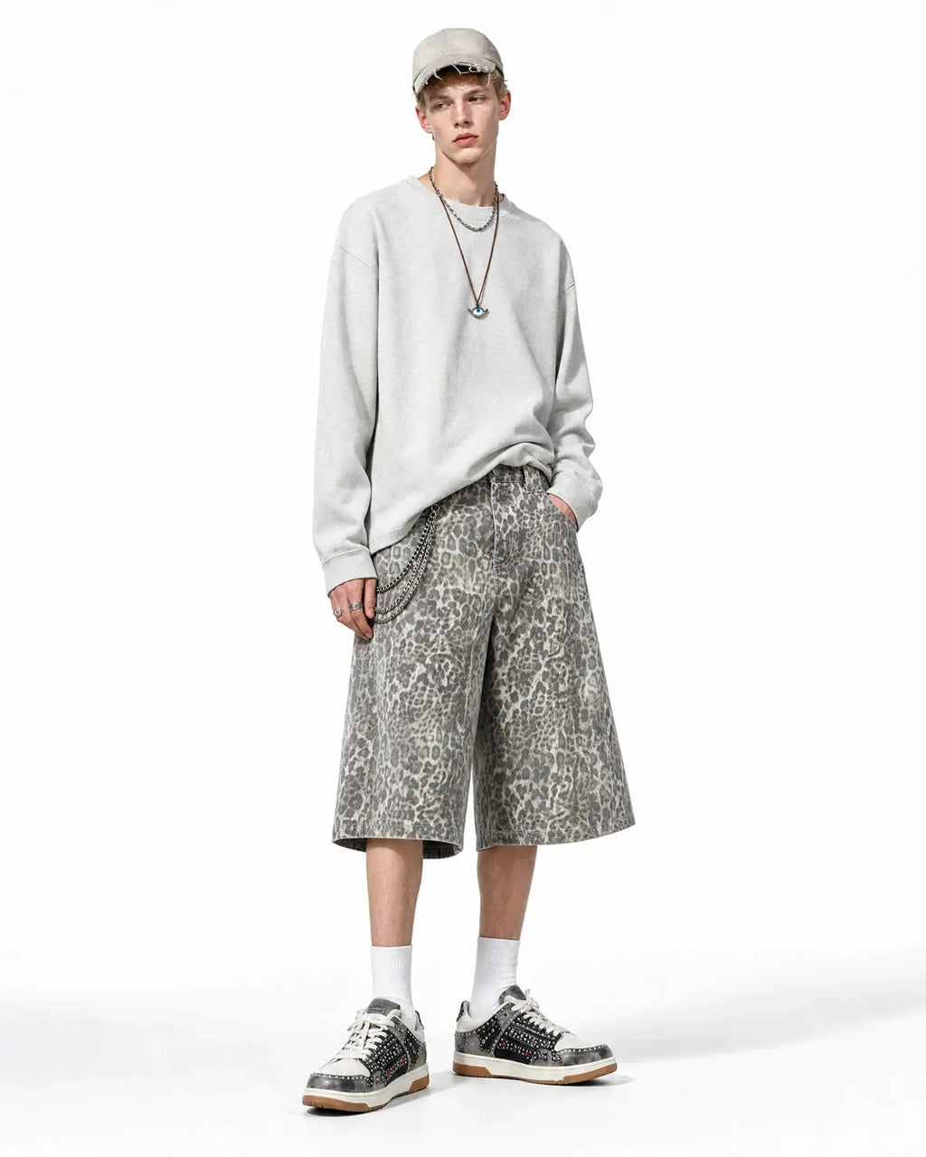 Leopard print baggy shorts by INFLATION, streetwear pants with loose fit and bold animal pattern, front view on white background.
