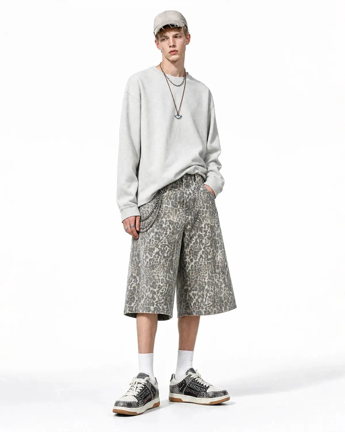 Leopard print baggy shorts by INFLATION, streetwear pants with loose fit and bold animal pattern, front view on white background.