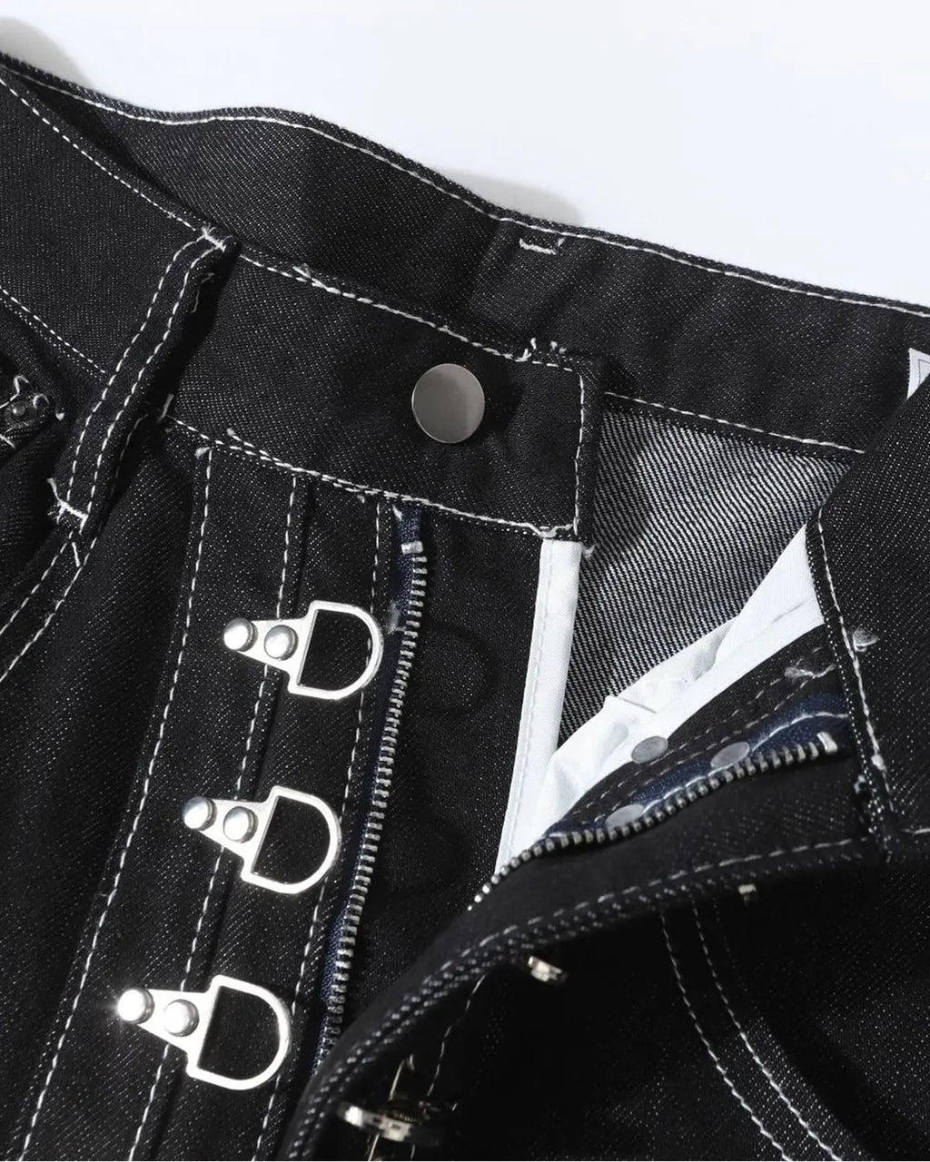 Raw metal clasp baggy jeans by INFLATION featuring a relaxed fit and distressed denim style.