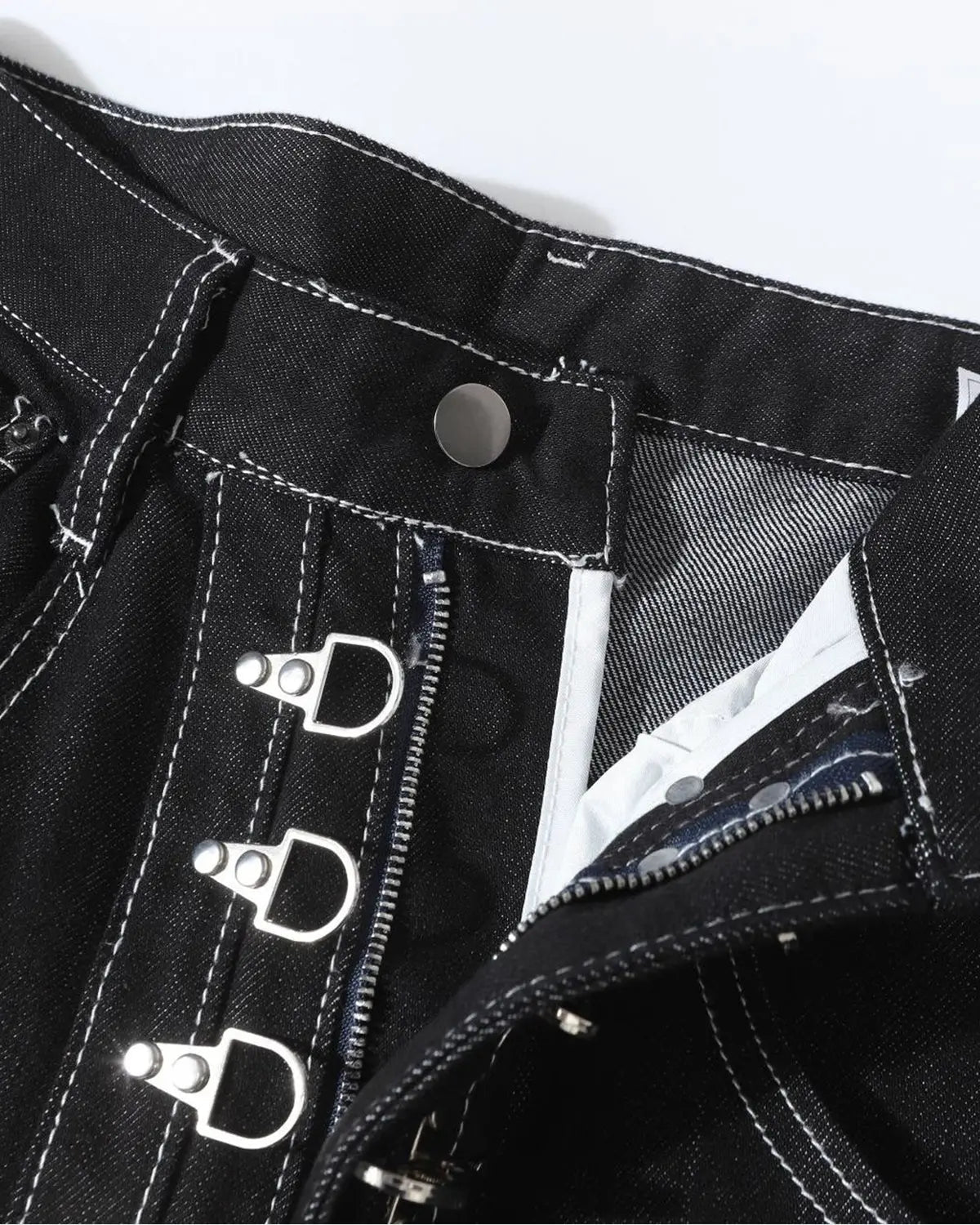 Raw metal clasp baggy jeans by INFLATION featuring a relaxed fit and distressed denim style.