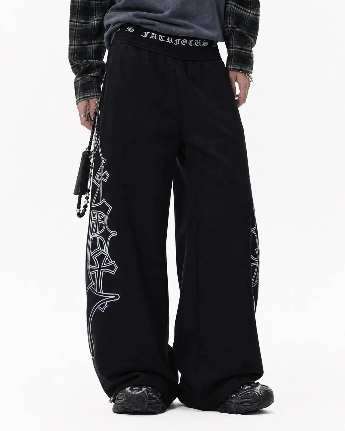 Gothic layered baggy sweatpants by INFLATION with an oversized fit, black fabric, and streetwear style, shown on a model.