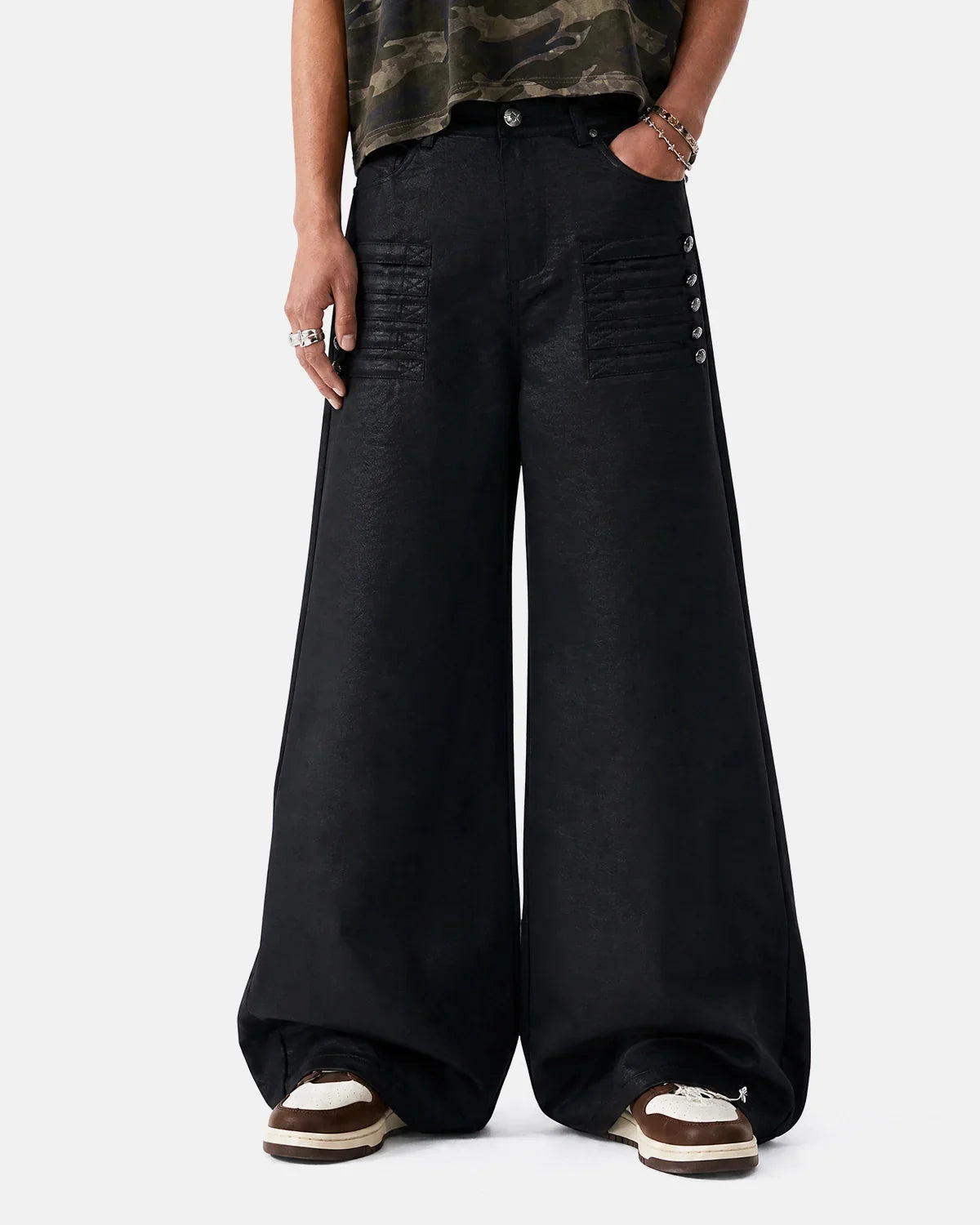 Black graphic wide leg pants by INFLATION featuring bold designs, relaxed fit, and wide-leg silhouette in a streetwear style.