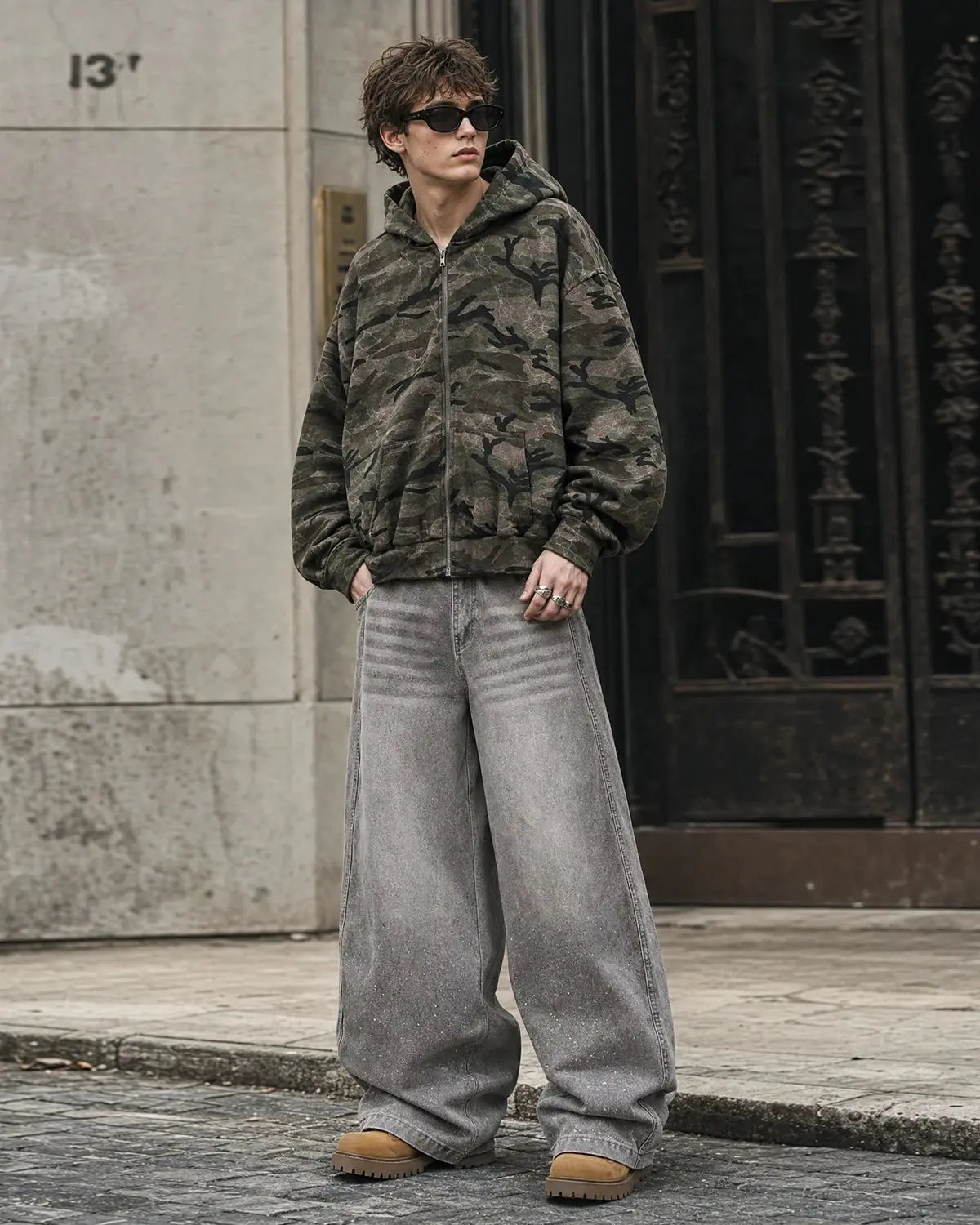 Inflation Streetwear camouflage zip-up jacket with hood, featuring a green and brown camo pattern and front zipper closure.