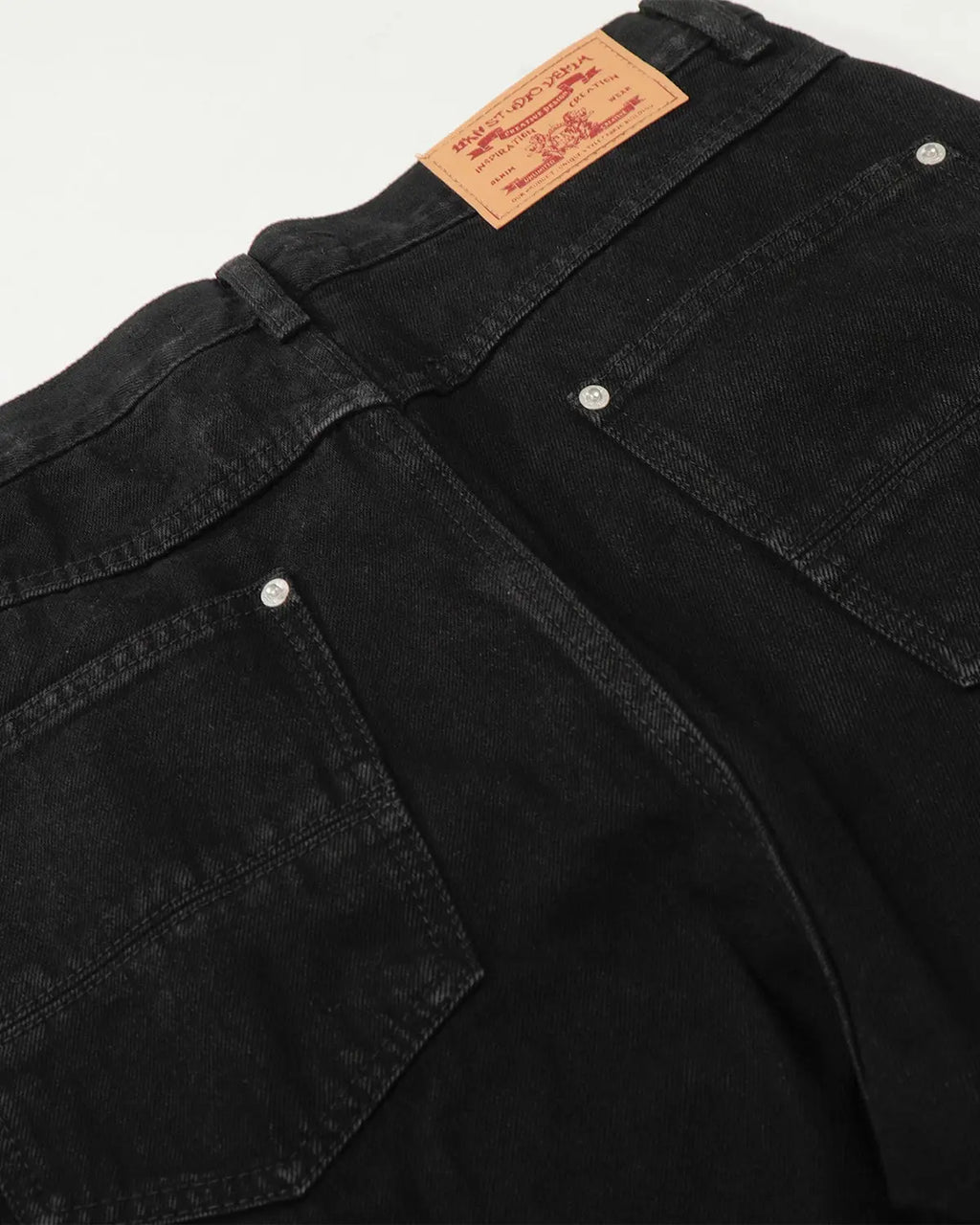 Black baggy jeans by INFLATION Streetwear featuring a relaxed fit and casual style, shown on a model.