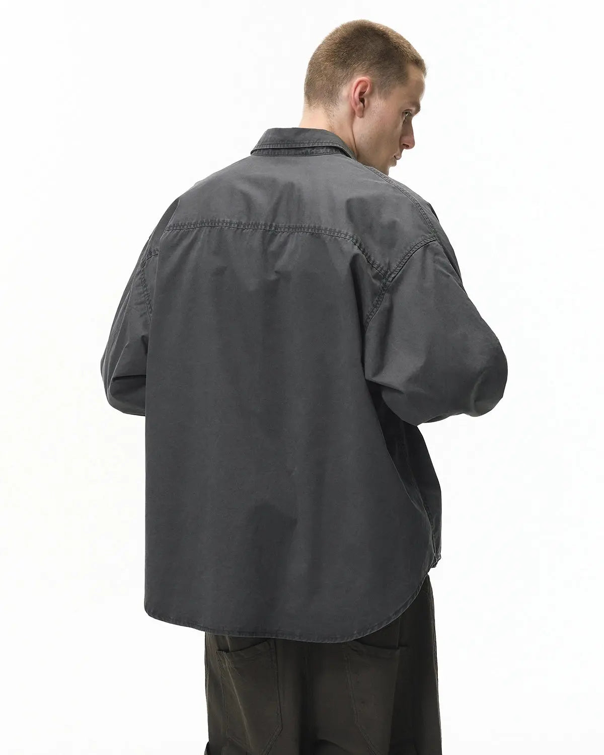 Acid wash cargo shirt jacket by INFLATION, streetwear style with multiple pockets and relaxed fit, shown on a hanger.