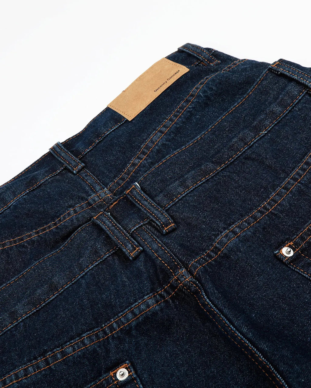 Inflation Streetwear double waist studded denim long jorts showing high-rise fit, studded details, and distressed denim fabric.