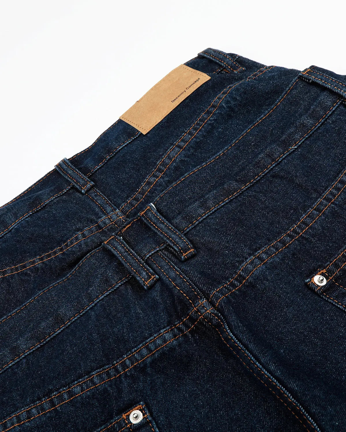 Inflation Streetwear double waist studded denim long jorts showing high-rise fit, studded details, and distressed denim fabric.