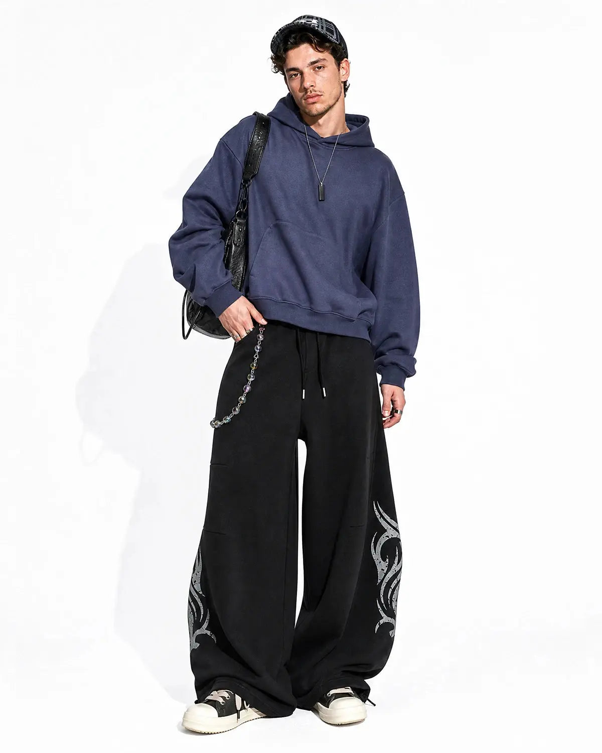 Washed distressed barrel sweatpants by INFLATION, showcasing a relaxed fit with ripped details and a comfortable streetwear style.