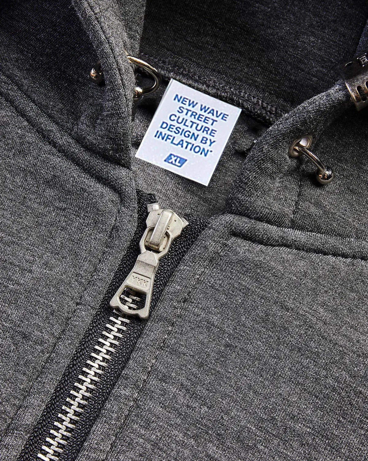 Grey boxy zip-up hoodie from INFLATION featuring a casual fit and front zipper, shown on a model.
