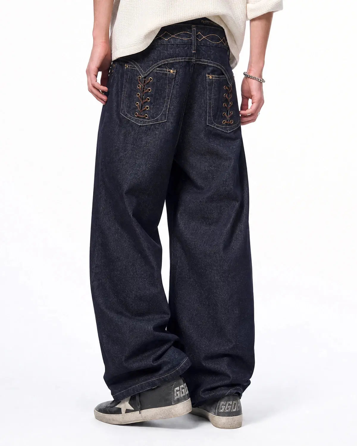 Raw baggy jeans with side lace-up design from INFLATION Streetwear, showcasing relaxed fit and distressed denim style.