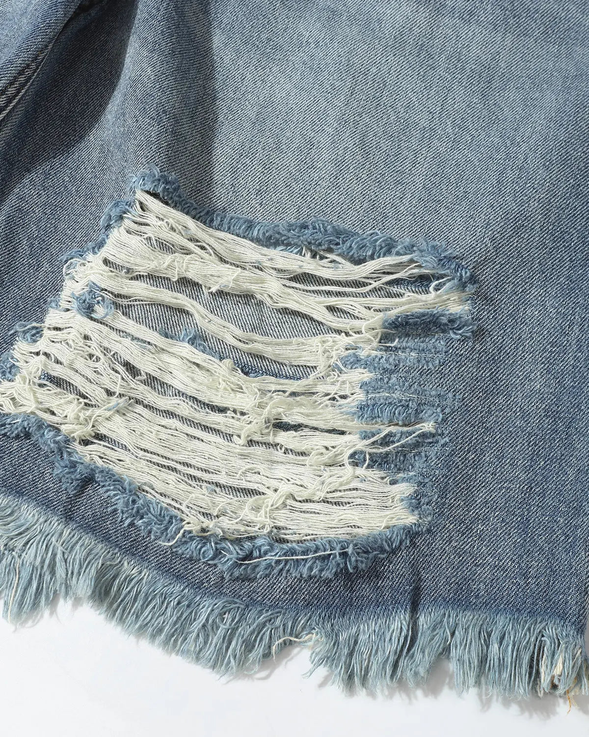 Distressed baggy jorts by INFLATION featuring adjustable waist tabs and a relaxed streetwear style.