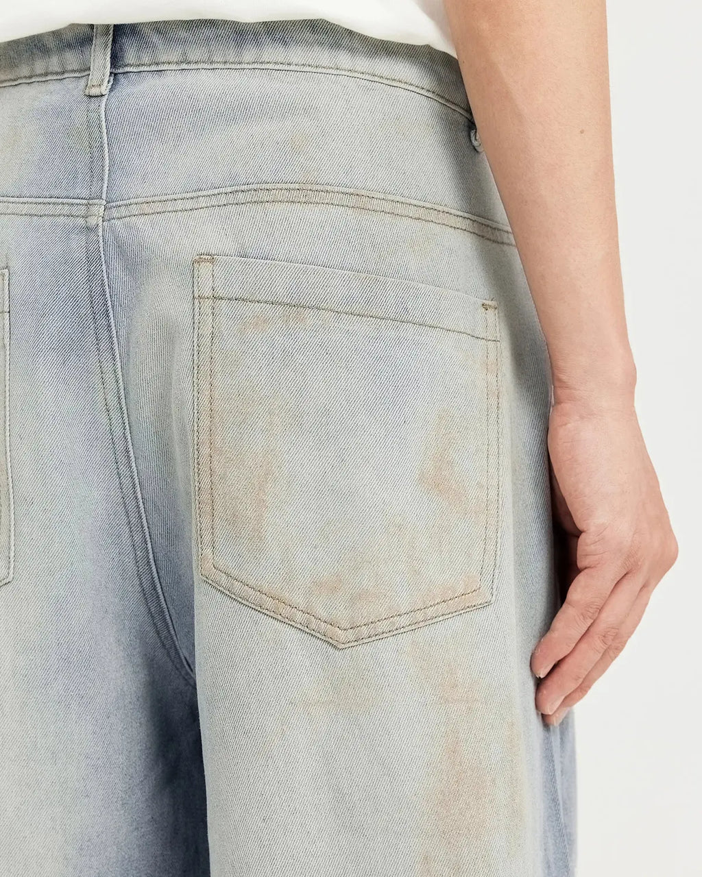 Inflation Mud Washed Baggy Jeans showing relaxed fit, distressed denim, and streetwear style on a model.
