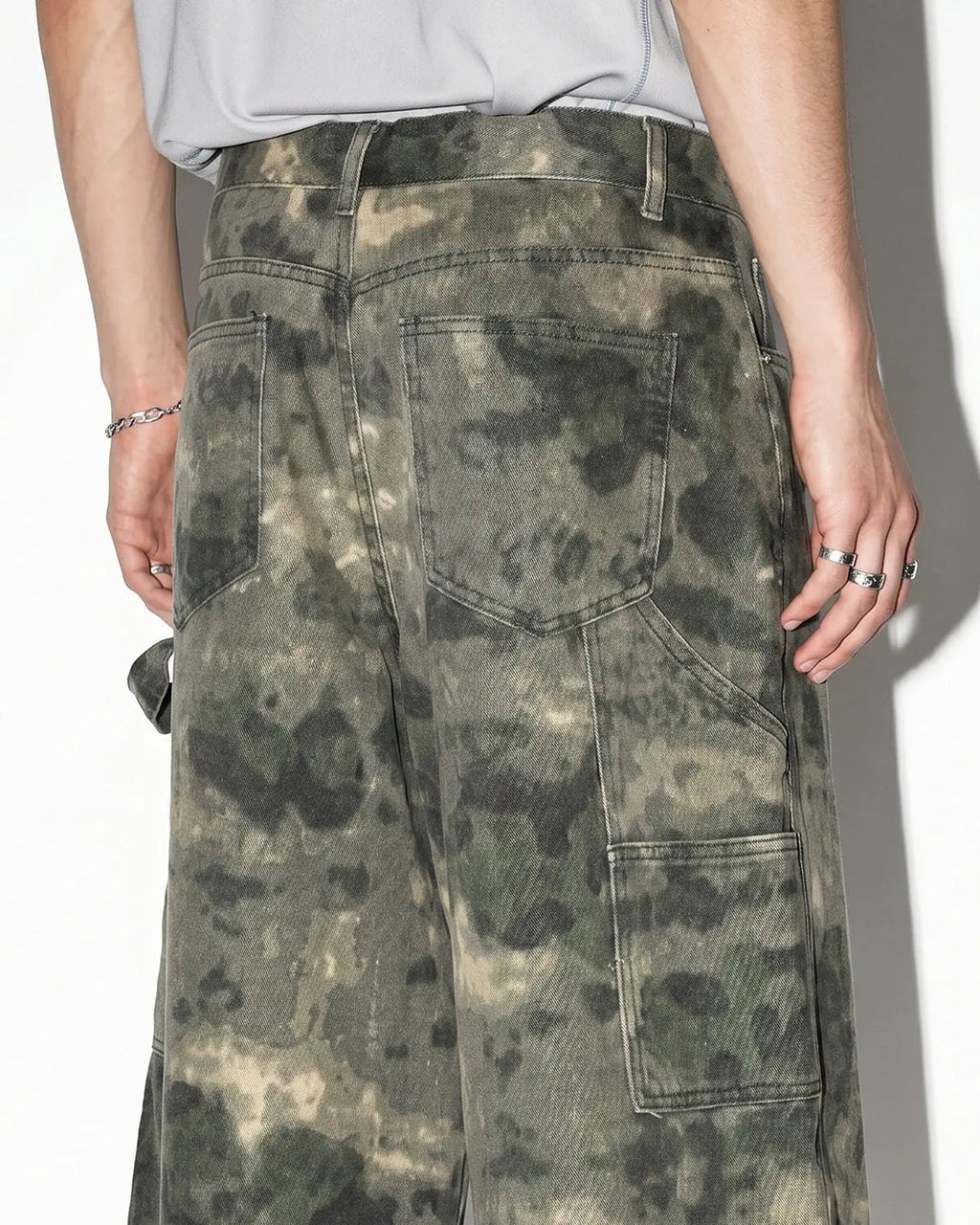 Washed camo cargo longline shorts by INFLATION featuring multiple pockets and a relaxed fit, styled for streetwear fashion.