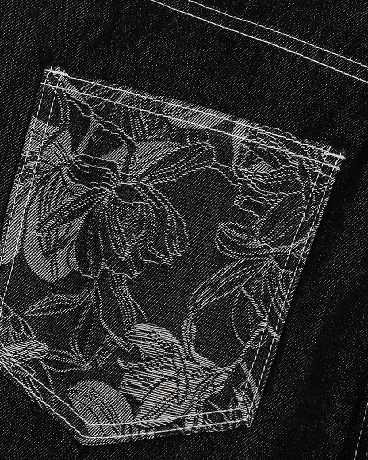 Inflation brand baggy denim jorts with embroidered pocket, showcasing loose fit and stylish detail on a pair of casual pants.