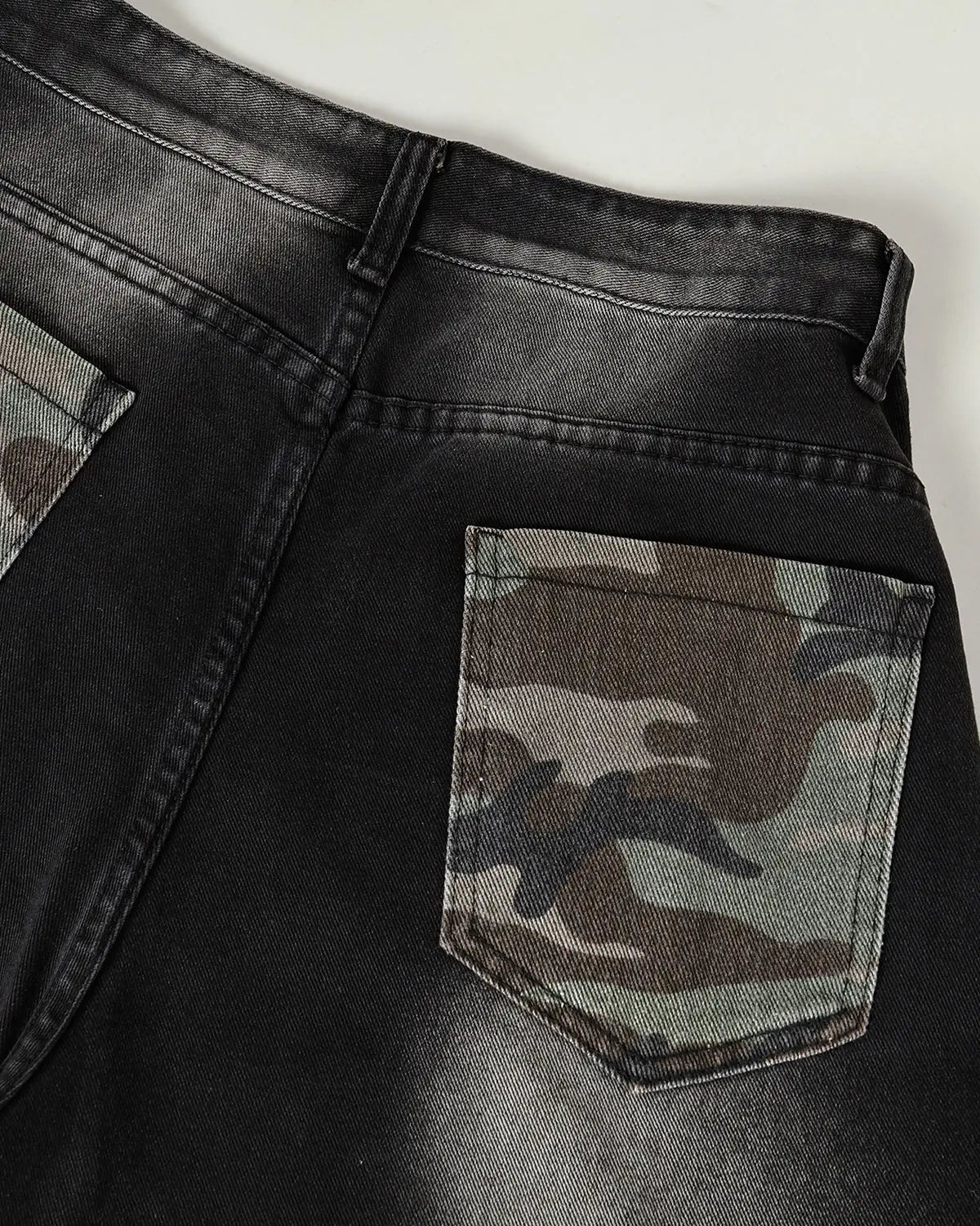 Inflation Spray Graphic Camo Barrel Jeans, stylish streetwear pants with bold spray pattern and relaxed fit, designed for urban fashion.