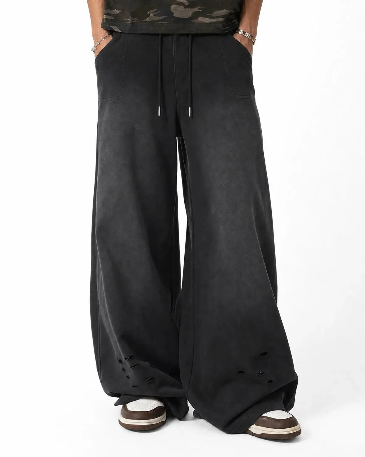 Distressed washed baggy sweatpants by INFLATION, featuring a relaxed fit and ripped details, casual streetwear style.