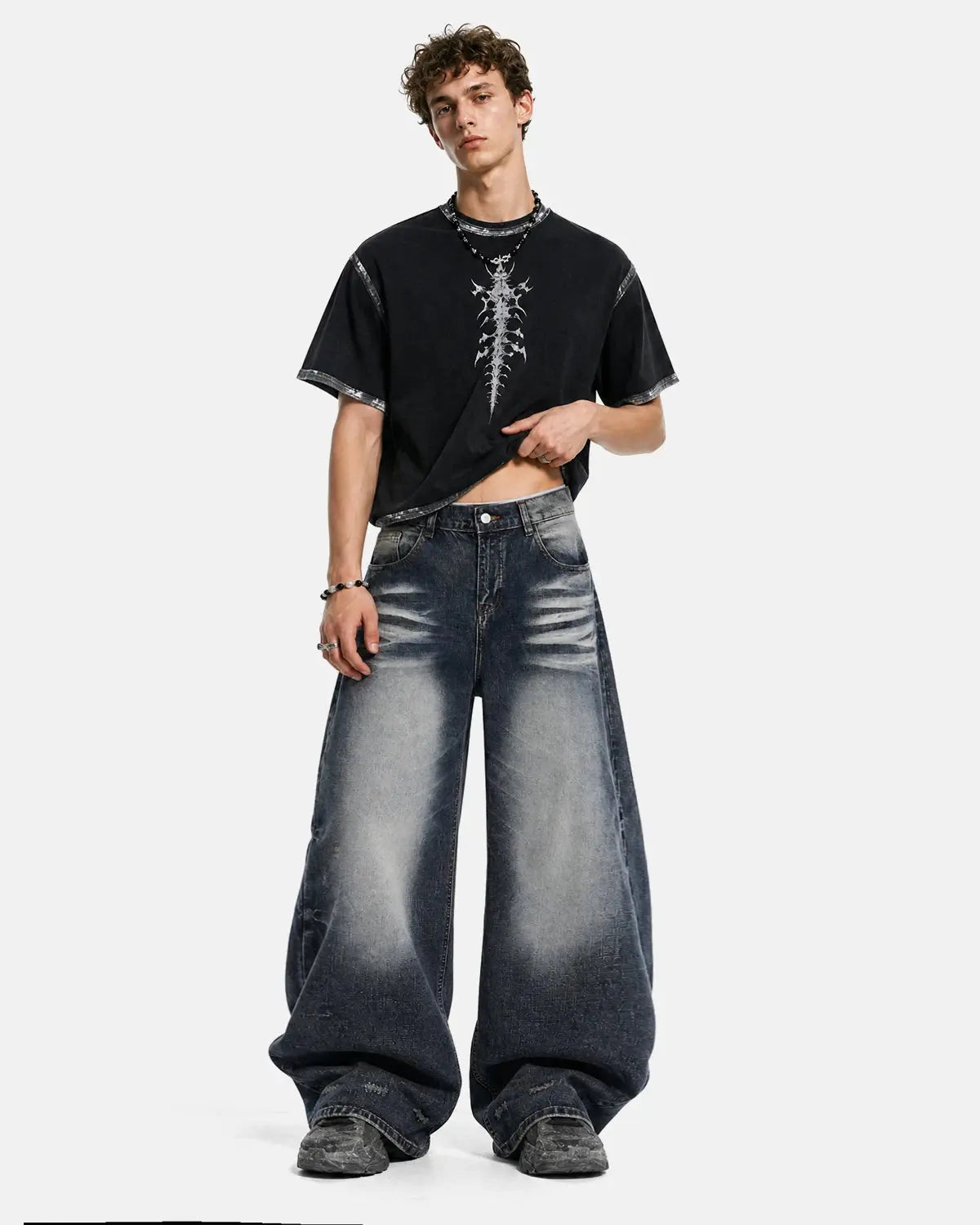 Faded Whisker Baggy Jeans by INFLATION, featuring distressed denim, relaxed fit, and whisker fading detail on front and back pockets.