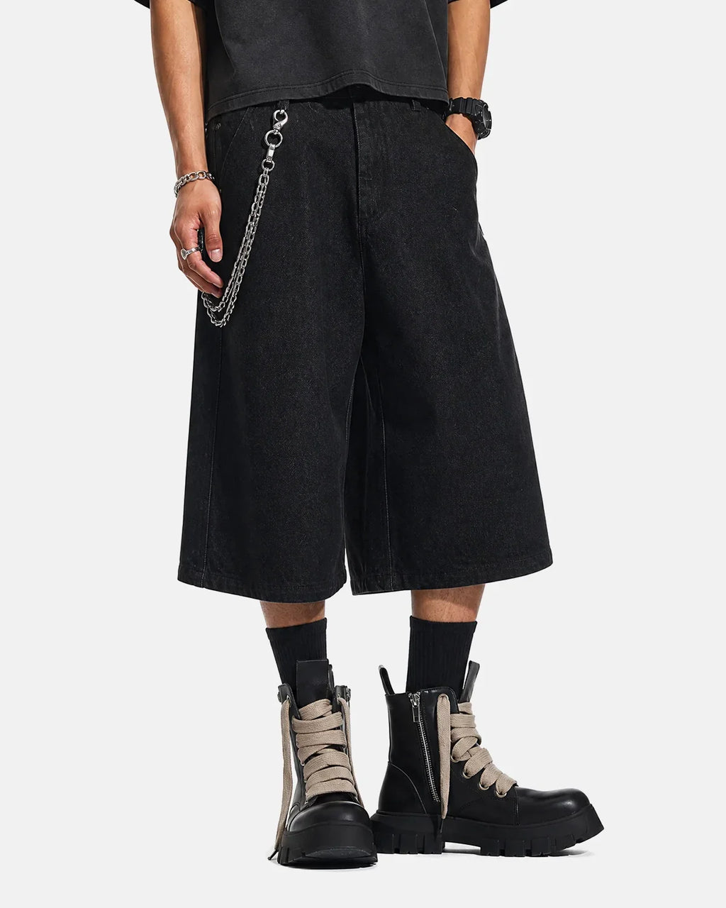 Black baggy long jorts by INFLATION, casual streetwear denim shorts with a loose fit and distressed details.