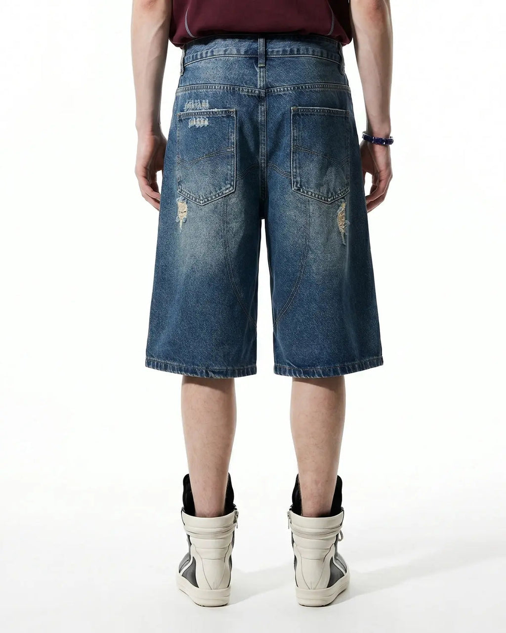 Heavy washed distressed baggy jorts by INFLATION, denim pants with a relaxed fit, featuring frayed edges and a vintage, worn look.