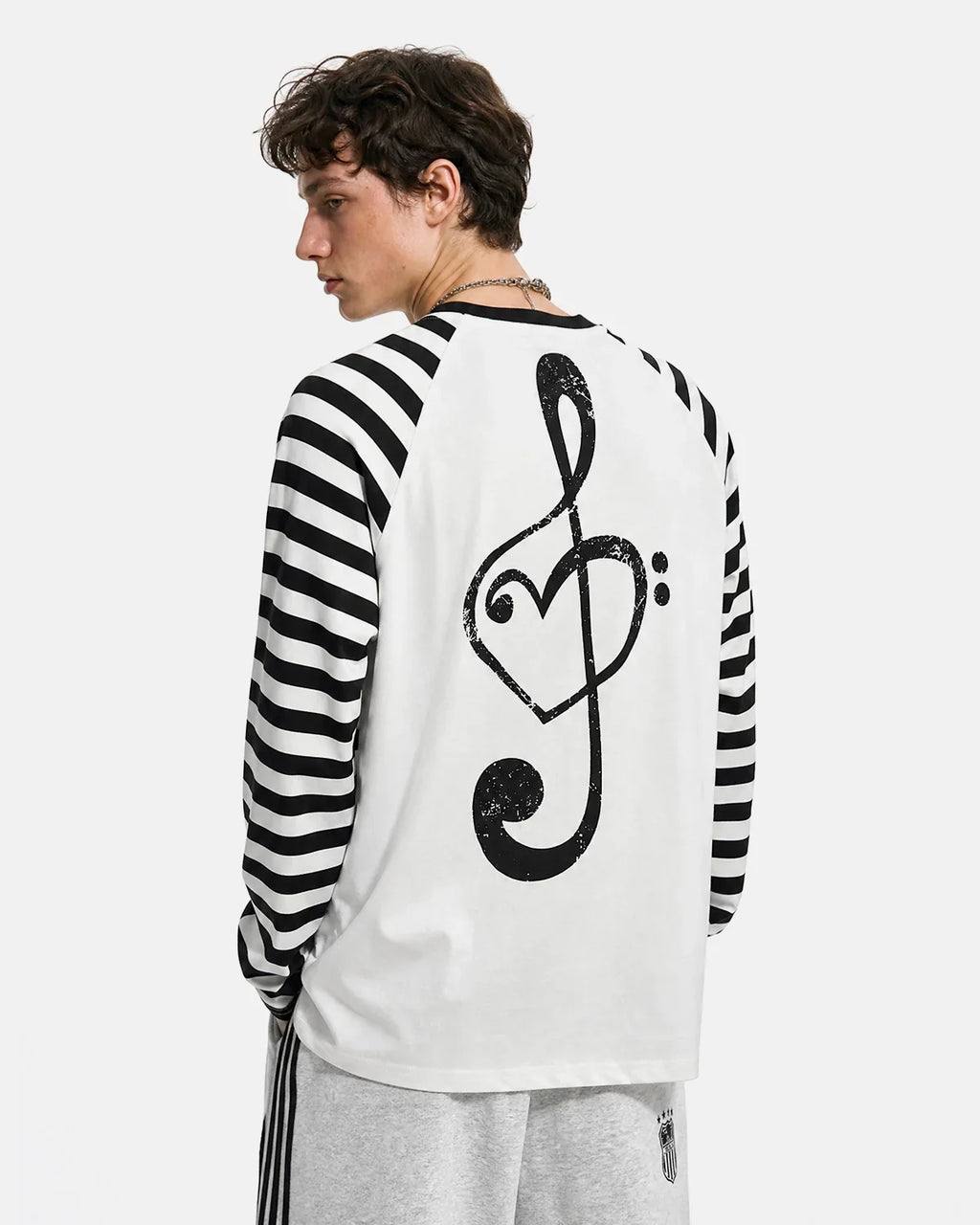 Inflation brand long sleeve T-shirt with music graphic and striped design, casual streetwear style, black and white colors.