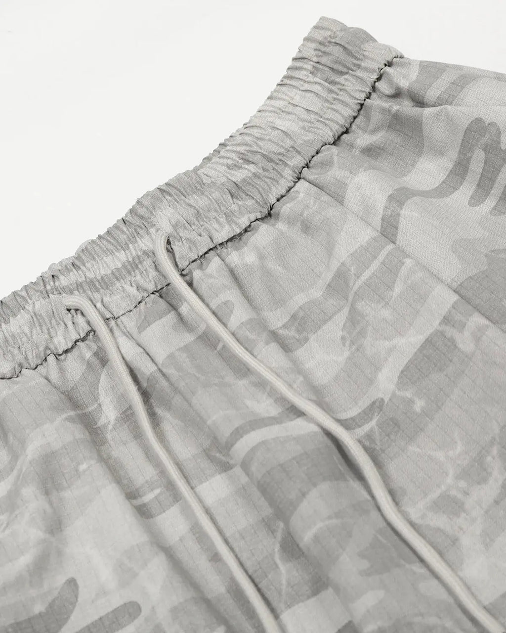 Camouflage cargo barrel pants by INFLATION featuring a streetwear style with multiple pockets and relaxed fit.
