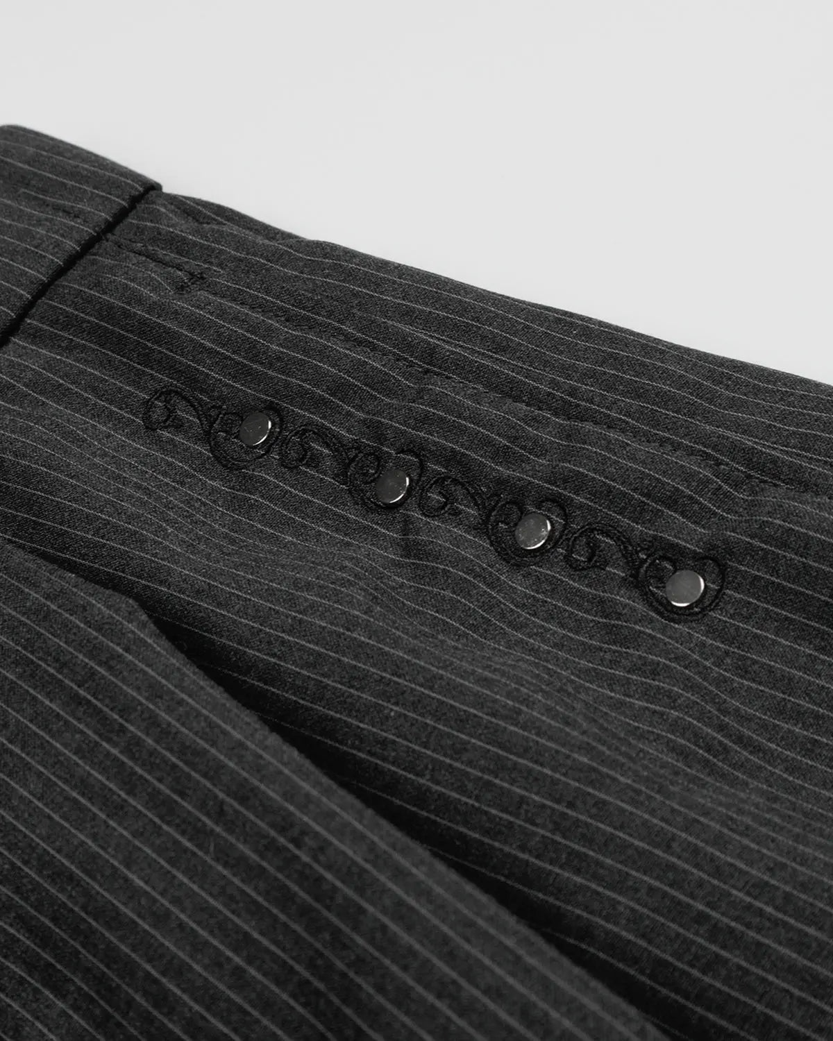 Pinstripe stud detail tailored shorts by INFLATION, stylish streetwear pants with pinstripe pattern and metal stud accents.