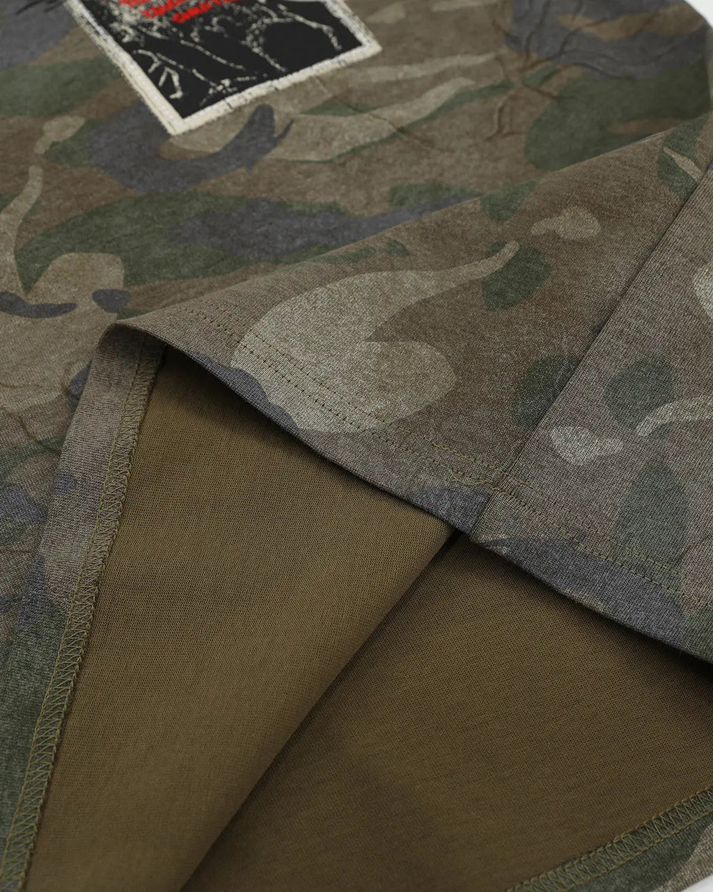 Vintage camouflage graphic T-shirt by INFLATION featuring a bold patch design and streetwear style.