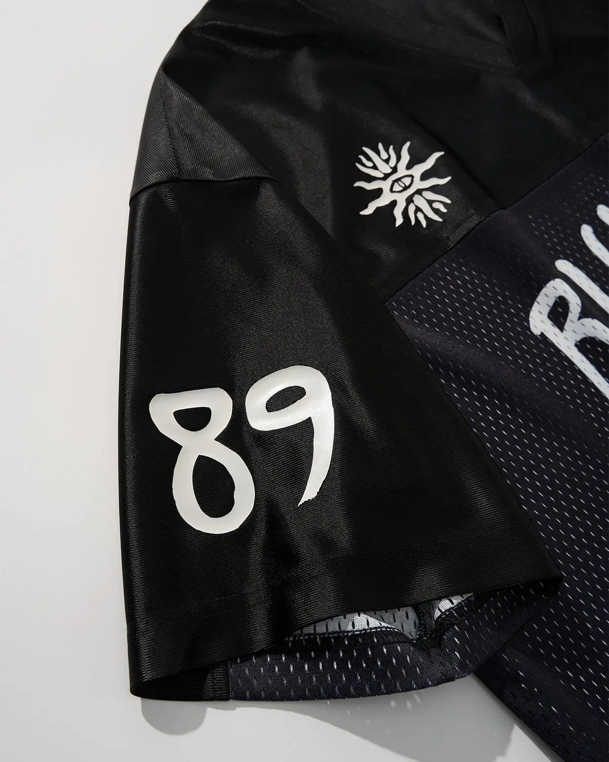V-neck mesh patchwork jersey tee by INFLATION, featuring breathable fabric and stylish streetwear design.