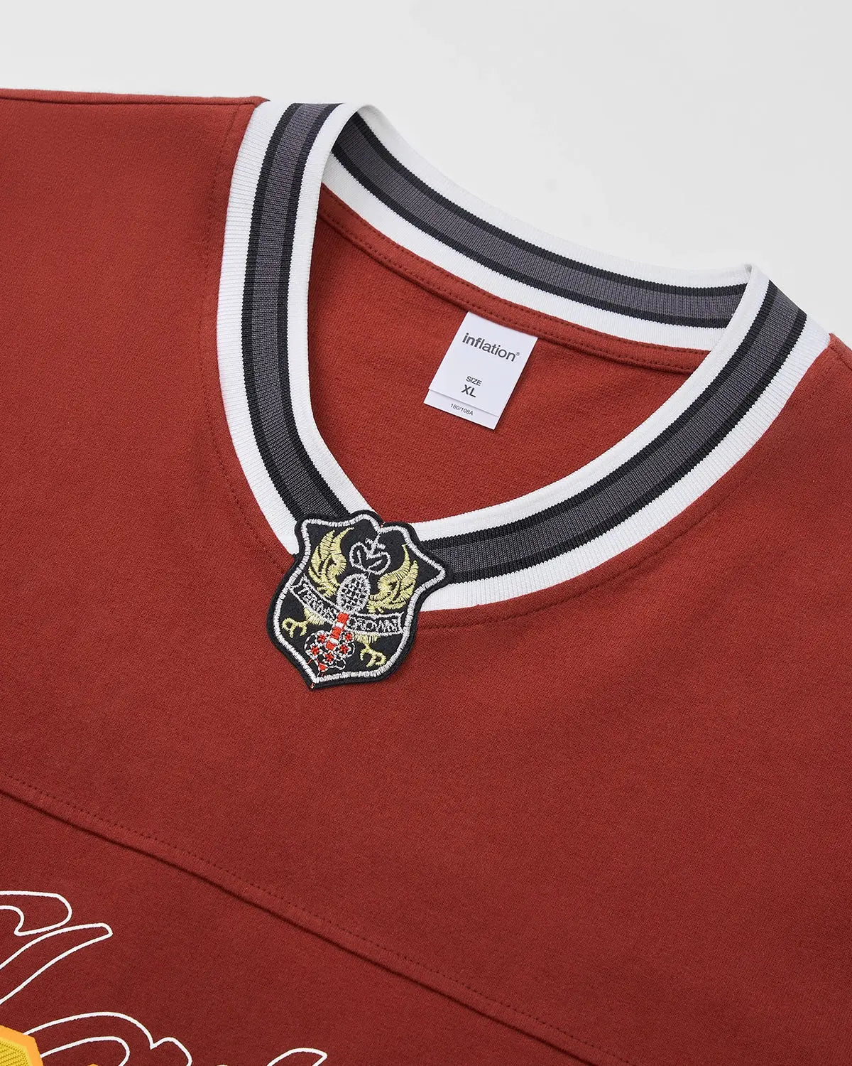 Retro V-Neck Jersey by INFLATION featuring bold stripes and a classic fit, displayed on a mannequin with a casual streetwear style.