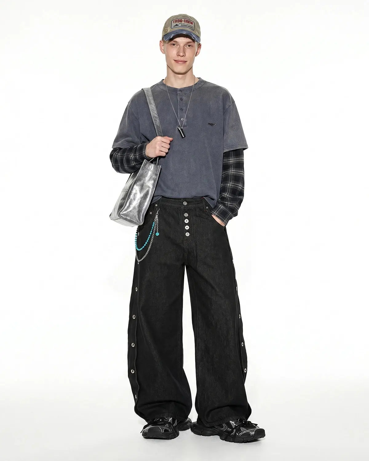 Inflation Streetwear barrel jeans with side eyelet buttons, featuring a relaxed fit and denim texture in a casual streetwear style.