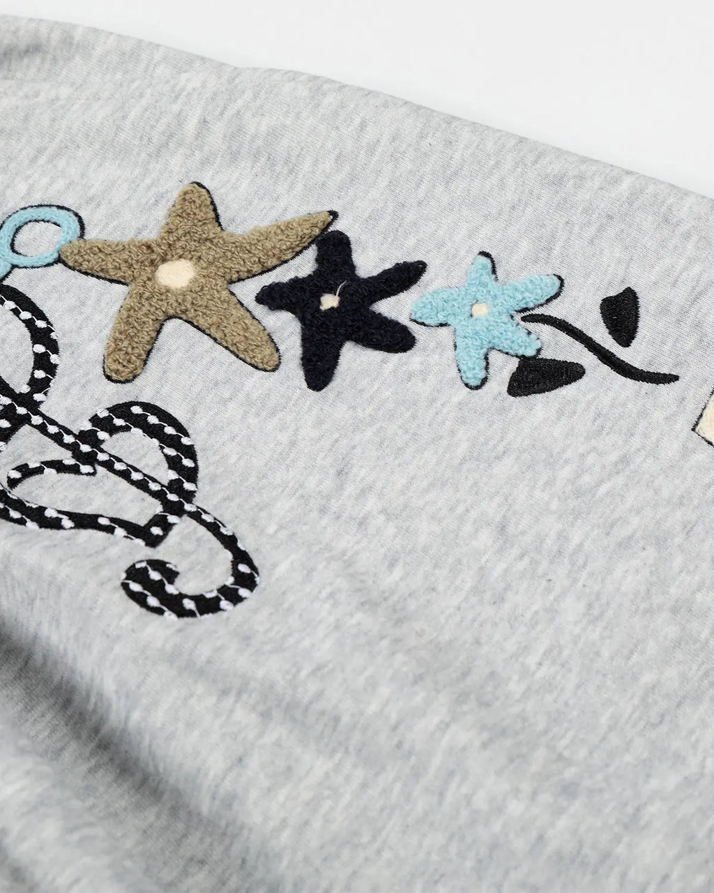 Inflation Streetwear Applique Baggy Sweatpants with bold logo patches and oversized fit, shown in black fabric.