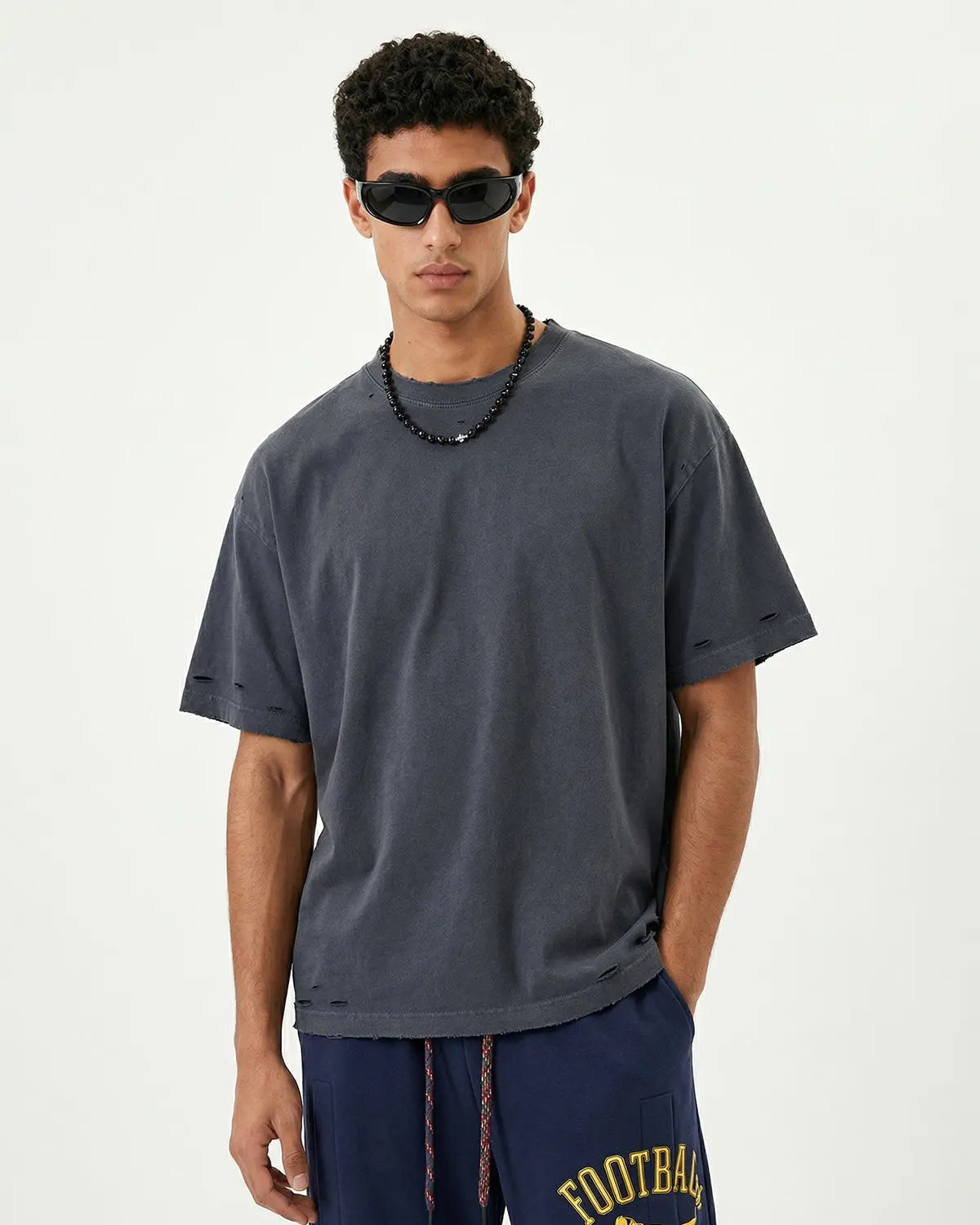 Inflation Streetwear oversized distressed washed T-shirt with ripped details and a relaxed fit, casual streetwear style.