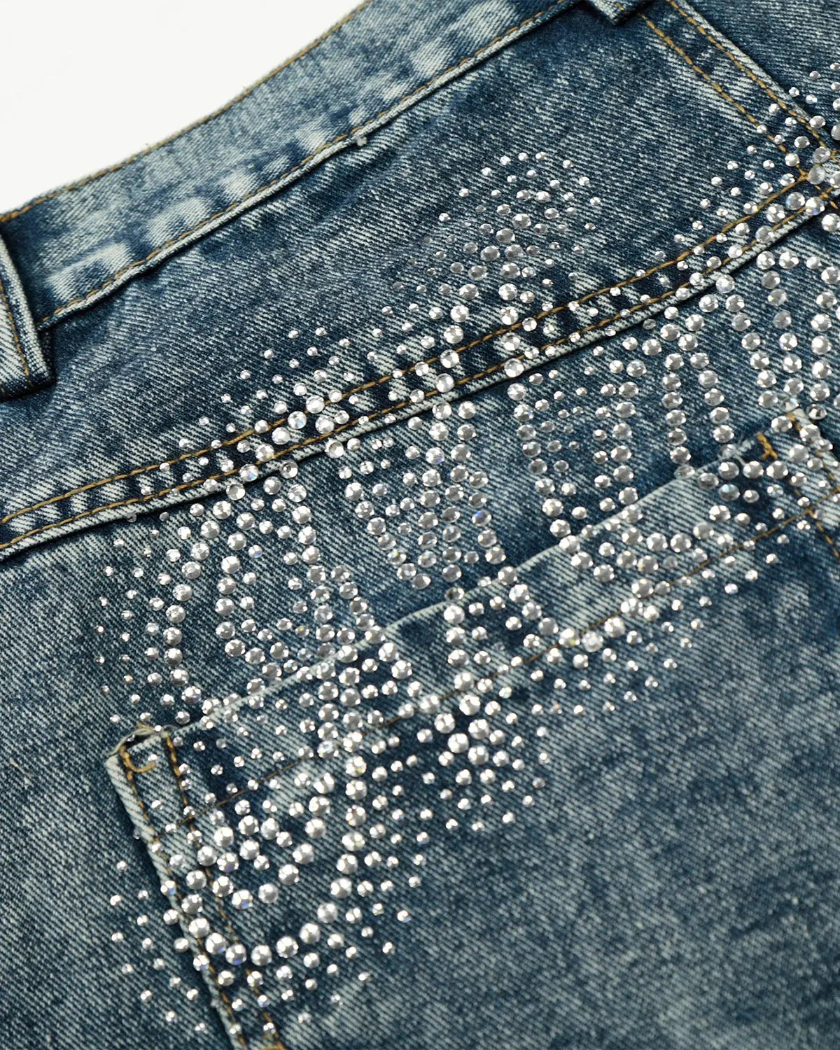 Rhinestone acid wash baggy jeans by INFLATION featuring distressed denim and loose fit, styled with rhinestone embellishments.